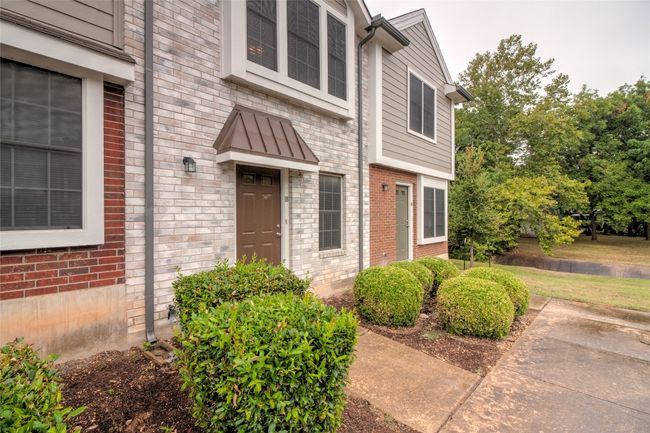 View of exterior entry featuring brick siding and a water view | Image 8