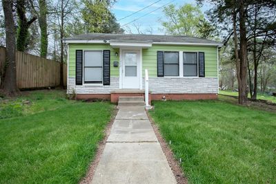 Envision your dream yard with this charming home as a canvas. Note: The lawn in the image has been digitally enhanced to suggest landscaping possibilities. | Image 3