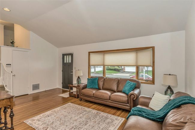 Living room with baseboards, vaulted ceiling, recessed lighting, visible vents, and wood finished floors | Image 11