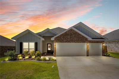 View of front of property with a garage and a lawn | Image 1