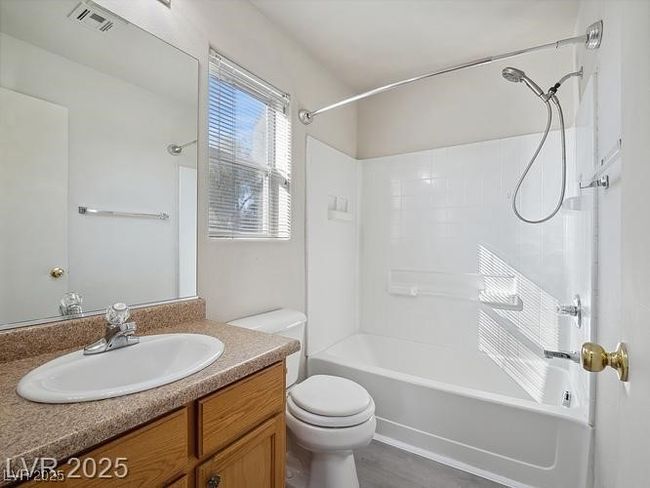 Bathroom with shower / tub combination, vanity, and dark wood finished floors | Image 13