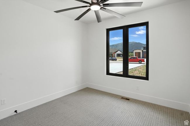 Spare room featuring light carpet and ceiling fan | Image 24