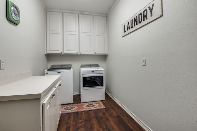 Laundry room featuring cabinet space and folding counter | Image 26