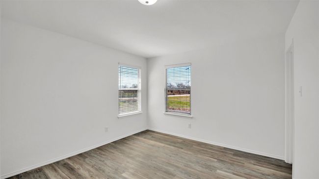 Spare room featuring baseboards and wood finished floors | Image 28