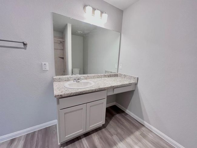 Experience the elegance of the master bath, beautifully enhanced through virtual staging. | Image 26