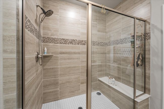Bathroom with a shower stall and tile patterned flooring | Image 26