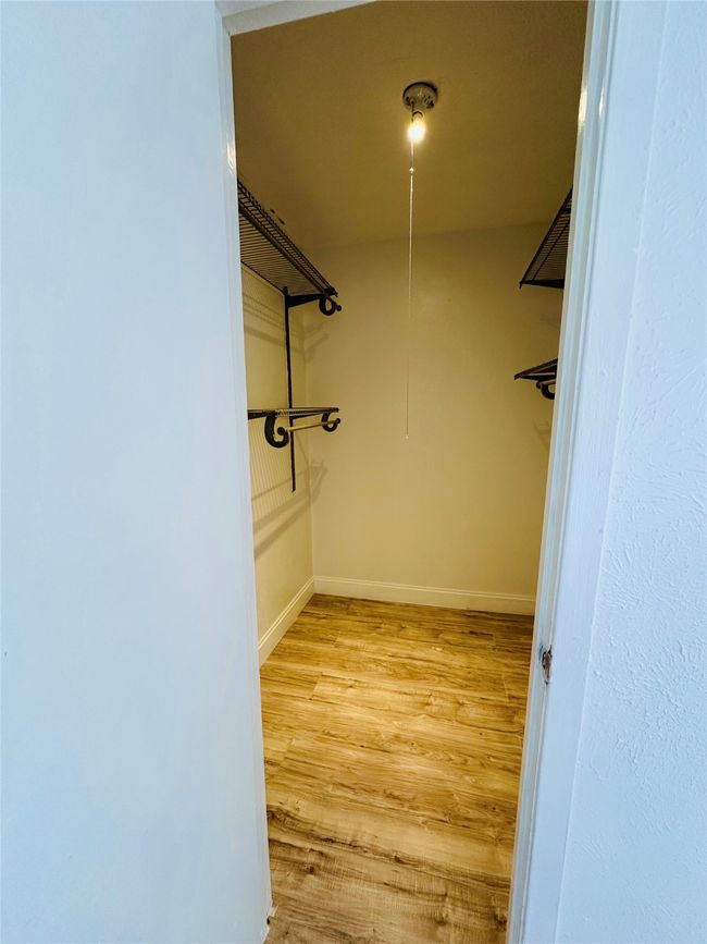 Walk in closet with light wood-type flooring | Image 14