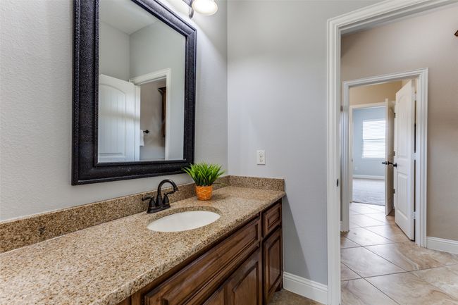The Jack and Jill style bath features extra large vanities with granite countertops. | Image 26
