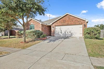 View of front facade featuring a front lawn and a garage | Image 2