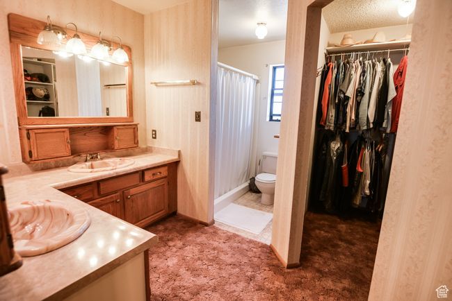 Bathroom featuring vanity, a shower with curtain, and a spacious closet | Image 21