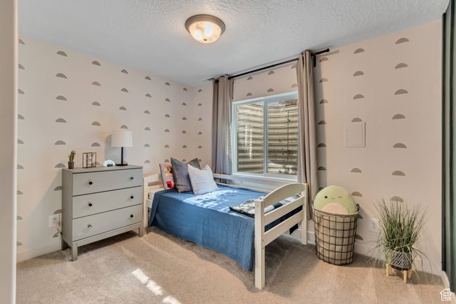 Carpeted bedroom featuring a textured ceiling | Image 25