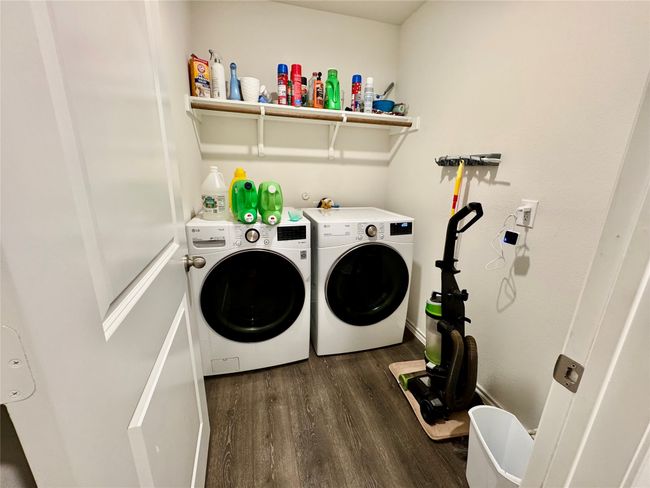 Washroom featuring washing machine and dryer, wood finished floors, and baseboards | Image 14