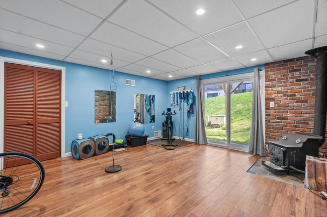 Finished lower level with wood burning stove. | Image 22