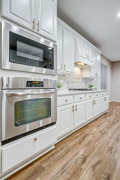 The built-in GE Profile oven and microwave are seamlessly integrated into the cabinetry, offering high-end functionality. The surrounding storage space and walk-in pantry ensures everything stays organized and within easy reach. | Image 3