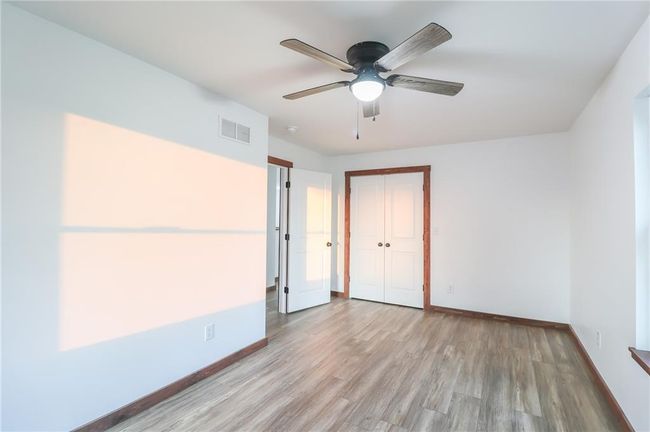 Unfurnished bedroom featuring a closet, light wood-type flooring, and ceiling fan | Image 27