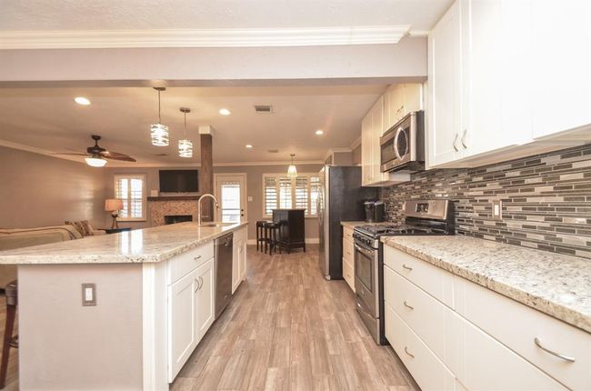 LARGE island with granite countertops, soft close cabinets, undermount sink and a great space to gather while prepping meals | Image 5