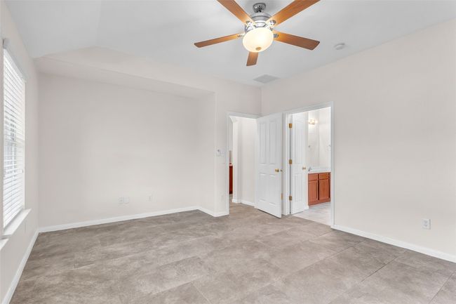 Unfurnished bedroom with a ceiling fan and connected bathroom | Image 15