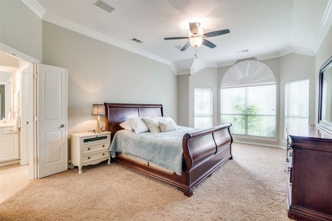 The primary bedroom overlooks the back yard and the pond. | Image 17