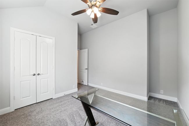 Unfurnished office with a ceiling fan, vaulted ceiling, and carpet | Image 27