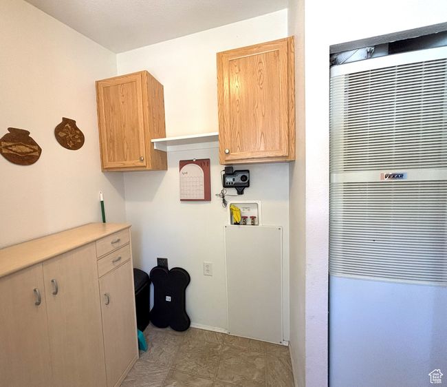 Laundry room with a heating unit, hookup for a washing machine, and baseboards | Image 47