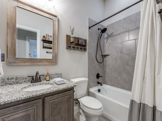 Full bathroom with vanity, shower / bath combo, and toilet | Image 25