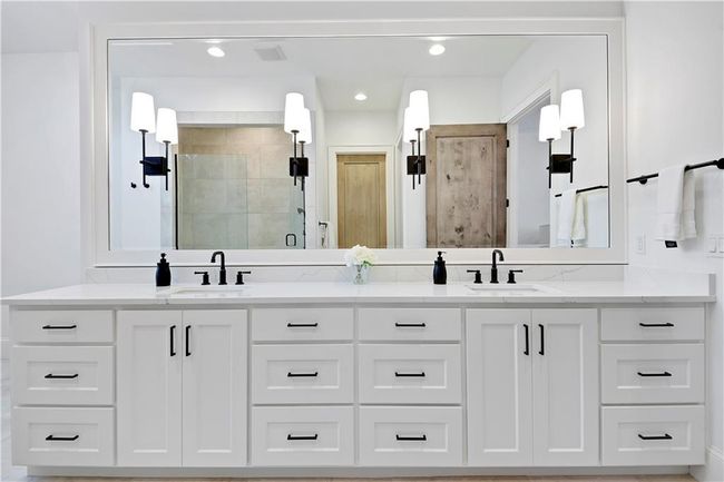Bathroom featuring recessed lighting, a sink, a shower stall, and double vanity | Image 33