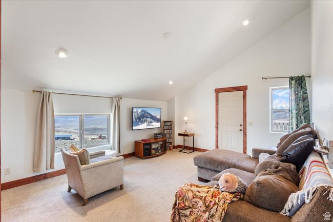 Living area with recessed lighting, baseboards, vaulted ceiling, and light carpet | Image 16