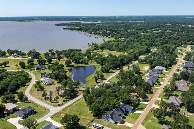 Aerial view of residential area featuring a large body of water | Image 4