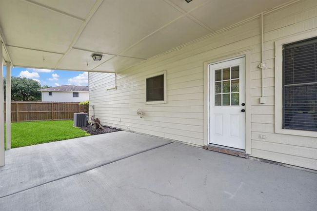 Backyard with a large covered patio | Image 21