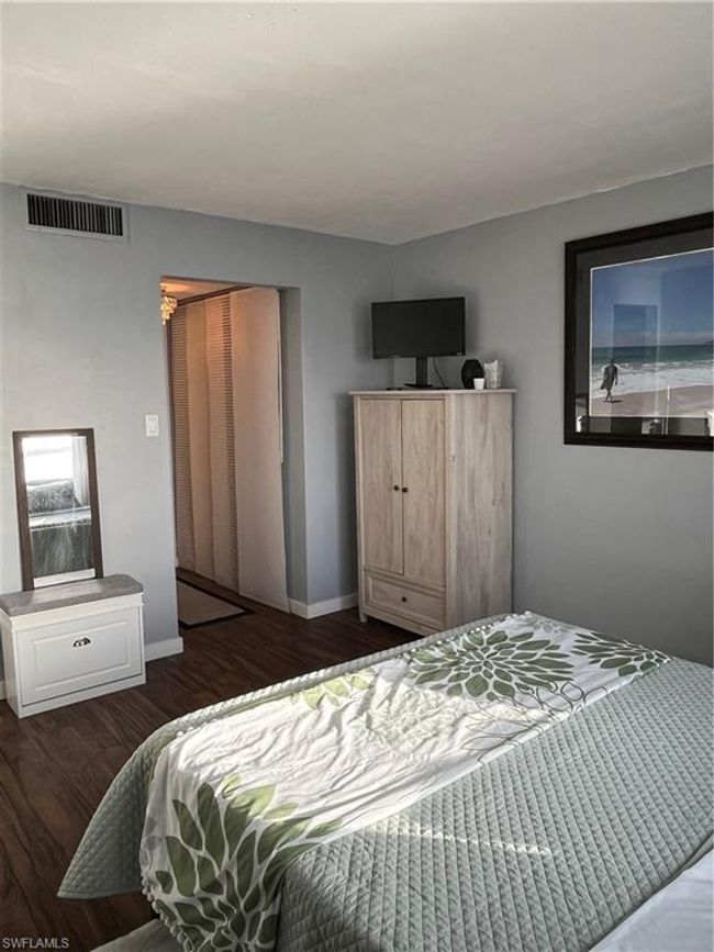 Bedroom with dark wood-type flooring and a closet | Image 11