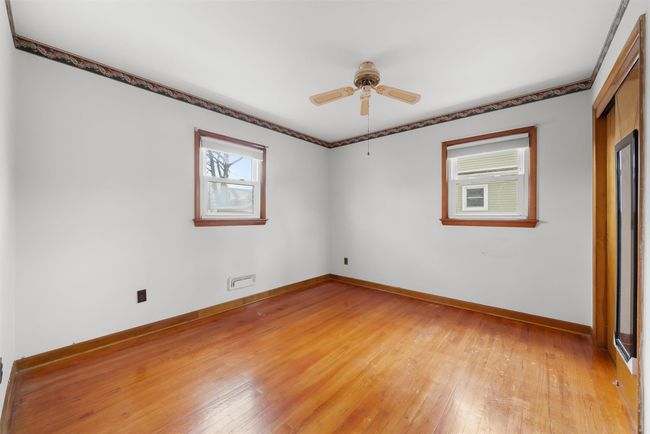 Spare room featuring light wood-style flooring, baseboards, and ceiling fan | Image 22