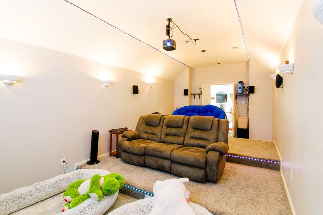 Carpeted cinema featuring lofted ceiling and baseboards | Image 21