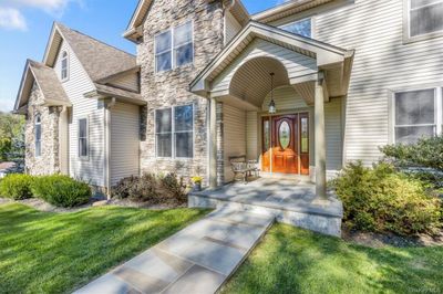 Property entrance featuring a yard and a porch | Image 3