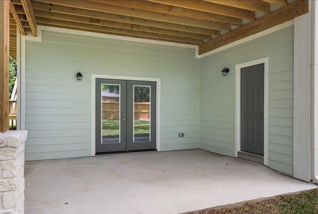 Downstairs back patio with french doors to the garage and access to the downstairs bathroom | Image 37