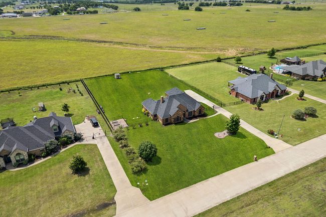 Aerial view of sparsely populated area featuring a pastoral area | Image 36