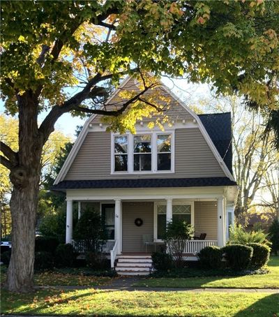 1900 built historic 3 BR/2BA Dutch Colonial in the heart of the Village of Honeoye Falls. Quaint front porch ideal for relaxing and taking in views of the neighborhood! | Image 1