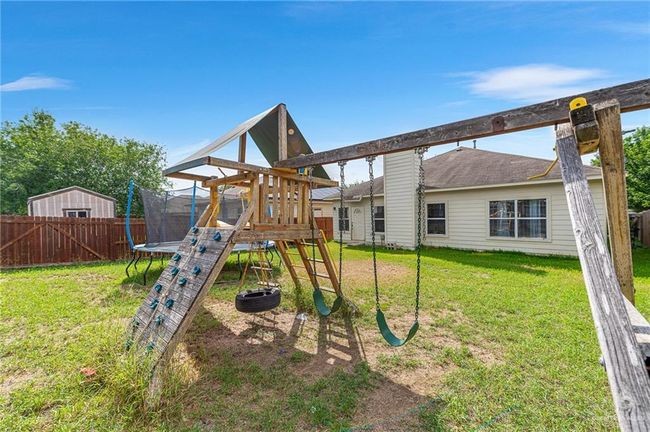 View of play area featuring a trampoline | Image 35