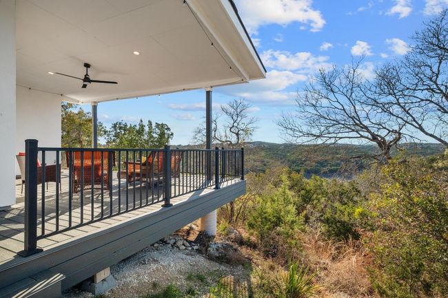 A captivating balcony offers a front-row seat to breathtaking panoramic views of the Hill Country, providing the perfect setting to relax, unwind, and take in the beauty of the surroundings. Thoughtfully designed for both elegance and comfort, this outdoor retreat enhances the home’s seamless connection to nature. | Image 32