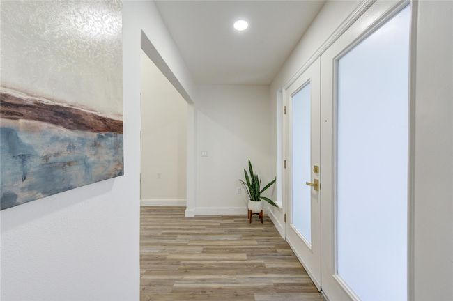 As you step through the front door, you're immediately greeted by a bright and airy entryway, bathed in natural light from the large new windows. | Image 5