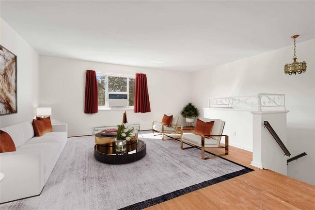 Living area featuring wood finished floors, a chandelier, and cooling unit | Image 5