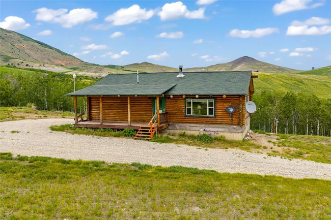 Cabin featuring a mountain view and log exterior | Image 26