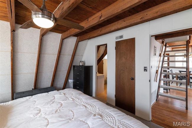 Bedroom with beam ceiling, wood finished floors, wood ceiling, and visible vents | Image 27