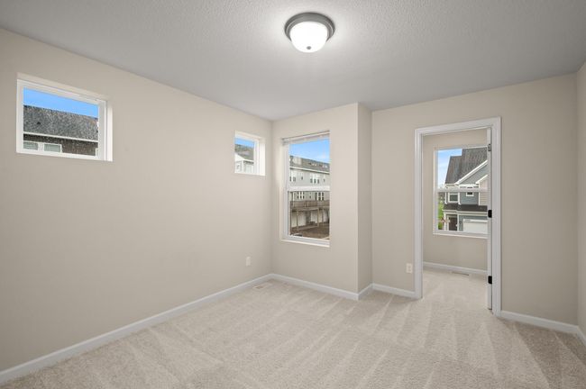 Upper level bedroom #2 with tons of natural light with the additional windows from the house being an end unit, also large walk in closet with a window to add even more light into the room. | Image 20