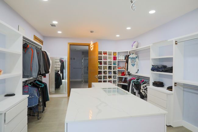 Walk in closet with light hardwood / wood-style flooring | Image 11