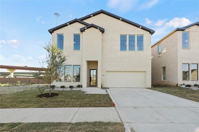 View of front facade featuring a garage | Image 1