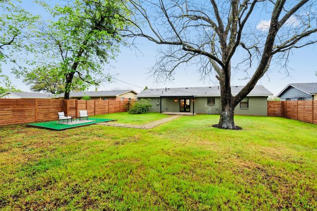 Fenced backyard with a patio | Image 38