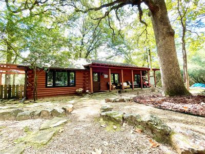 Log cabin featuring a patio | Image 1