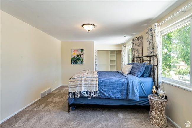 Carpeted bedroom with multiple windows | Image 40