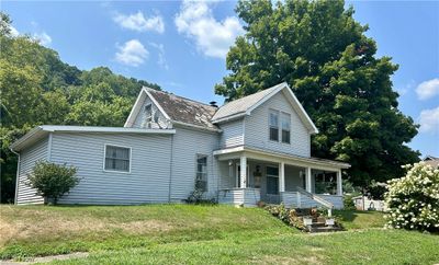 View of front facade featuring a porch and a front yard | Image 1