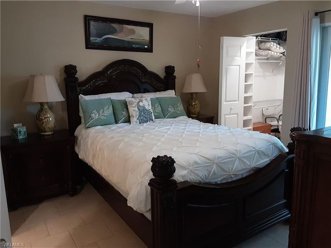 Bedroom featuring a walk in closet and light tile patterned floors | Image 14
